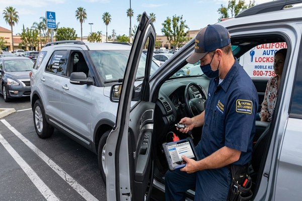 Auto locksmith programming a car key for a Belmont CA vehicle